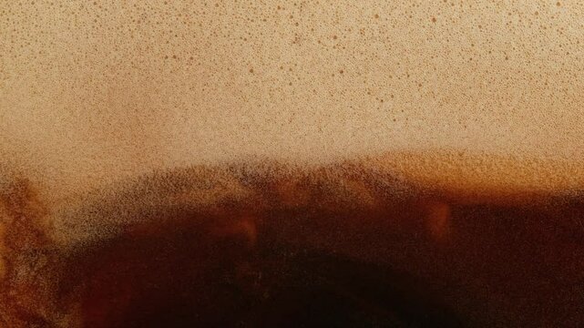 Super Slow Motion Detail Shot of Swirling Coffee Cream at 1000fps.