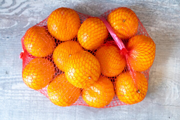 Enjoy Fresh Oranges Stored in a Bright Red Net Bag, Perfect for Healthy and Tasty Snacking
