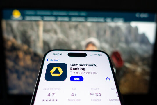 Kiel, SH, Germany - March 13, 2025: Mobile phone displaying the german banking app of the Comerzbank in the App Store on the screen in front of the business website.