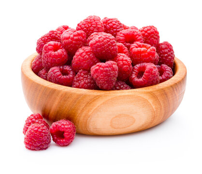 Ripe raspberries in wooden bowl isolated on white background