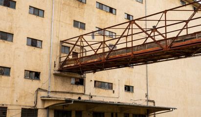 Abandoned industrial building with rusted walkway
