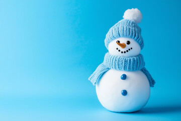 Blue snowman figure isolated on a blue background