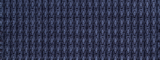 Texture navy blue fluffy fabric background with pattern, macro. Abstract backdrop from dark denim textile