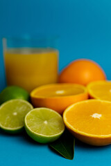 Close-up of cut oranges on a table. Orange juice in a glass