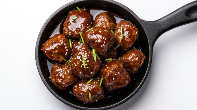 Sticky honey BBQ beef bites served in a cast iron pan, showcasing a delicious and savory dish perfect for any occasion