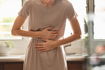 Stomach ache. Woman having abdominal pain, indigestion, gastritis, menstrual cramps, flatulence,...