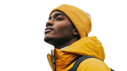 Young man in bright yellow jacket and beanie gazes upward in a minimalist background