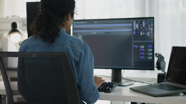 During the day, Asian software engineers engage with digital designs and programming languages, overseeing tech projects at a modern company office.