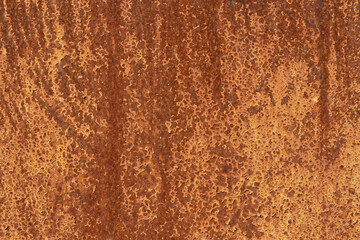 Close-up of a rusted metal surface with a rough, textured pattern. The corroded material displays...