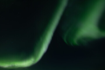 Amazing view on the Northen light over high mountains covering with snow, forces of nature, Aurora Borealis, Iceland, Norway, Finland, Sweden.