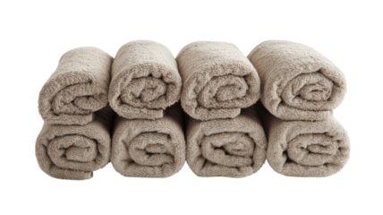 Neatly rolled beige towels stacked in a bathroom for a fresh and organized look