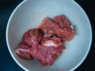 Fresh and highquality raw meat presented in a bowl, ideal for cooking delicious meals