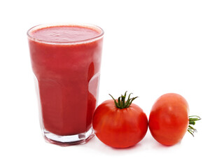 Glass of tomato juice and tomatoes.