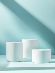 Modern Minimalist Display of Three White Cylindrical Pedestals