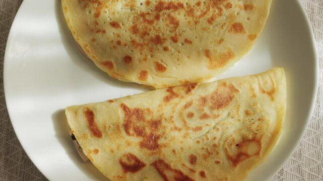 Quesadilla with a lot of fried pork and cheese on a plate. High quality 4k footage