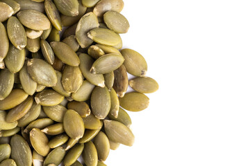 Pumpkin seeds over white background.