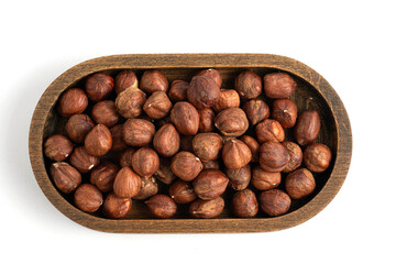 Hazelnuts in wooden bowl isolated on white background. Top view.