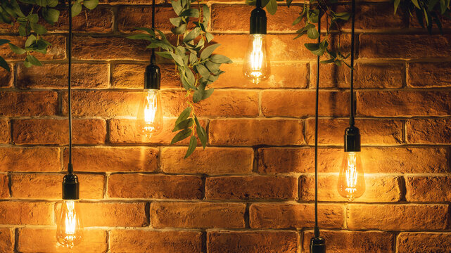 Decorative incandescent bulbs in Edison style on a brick wall background