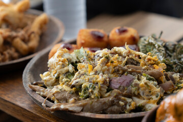 Scrambled eggs with mushrooms and ham Spanish appetizers on table