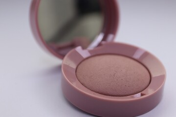 Beige pearlescent eyeshadow in an open case with a mirror