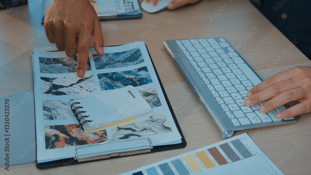 Poster a modern workspace scene featuring hands pointing at a colorful mood board alongside a keyboard and 