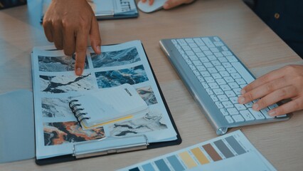 A modern workspace scene featuring hands pointing at a colorful mood board alongside a keyboard and a notebook, reflecting the design and creative process in action. SACTR