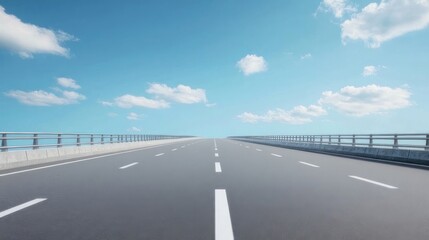 Fototapeta premium Empty highway stretching into a bright blue sky
