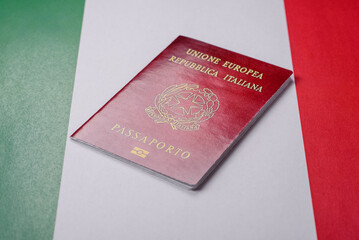 Italian citizen passport against the background of the national flag of Italy