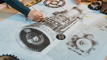 This image showcases a detailed engineering drawing of a jet engine, with hands actively sketching...