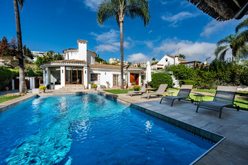 a poolside image in luxury mediterranean villa real estate property
