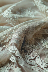 Close-up of elegant sheer tulle fabric with delicate floral embroidery in ivory tones. Romantic and luxurious texture ideal for wedding dress design, bridal fashion, or vintage-inspired styling.