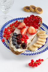 Delicious Breakfast with Toast, Berries, and Chocolate Cookies on a Light Background