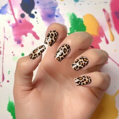 Artistic representation of a person's hand showcasing trendy leopard print nail art design