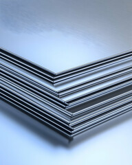 Stacked metal sheets.  A close-up view of several metal sheets neatly stacked