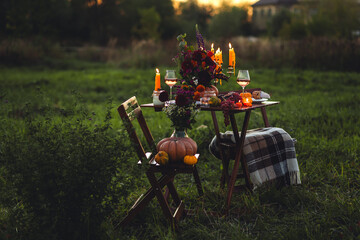 Fall table decoration with pumpkin composition. Family cozy thanksgiving dinner arrangement...