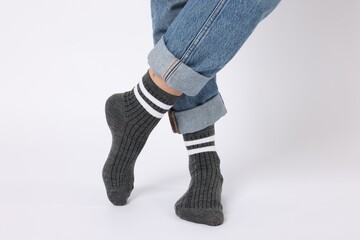 Woman wearing gray socks on white background, closeup