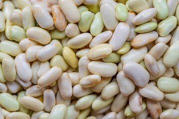 Close-up of raw white beans with natural texture and earthy tones. Fresh legumes, perfect for healthy cooking and plant-based nutrition.