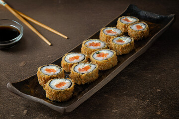 Hot fried sushi roll with salmon and cream cheese. Sushi menu. Japanese food. © Lipe
