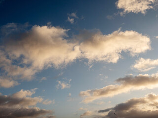 The sky is blue with a few clouds scattered throughout. The clouds are white and fluffy, giving the sky a peaceful and serene appearance