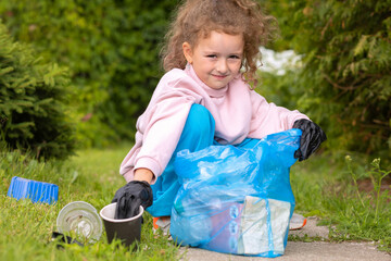 Girl collection plastic garbage in nature. kid picking up trash in park. Earth Day April 22. Save...