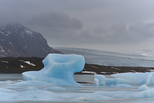 Blue icebergs floating on jokulsarlon glacier lagoon in iceland - Powered by Adobe