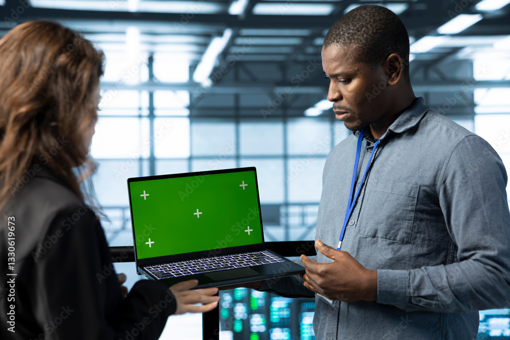 Poster team of engineers working in server farm, using green screen laptop to analyze data. employees exami