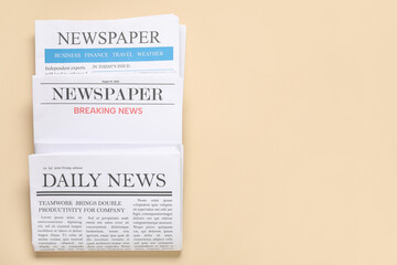 Different newspapers on beige background