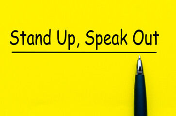 Stand Up and Speak Out Courage text on yellow notepad. Speak up culture