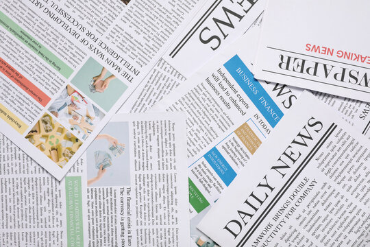 Different newspapers as background, closeup