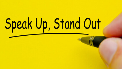 Speak up and stand out text on yellow cover background.