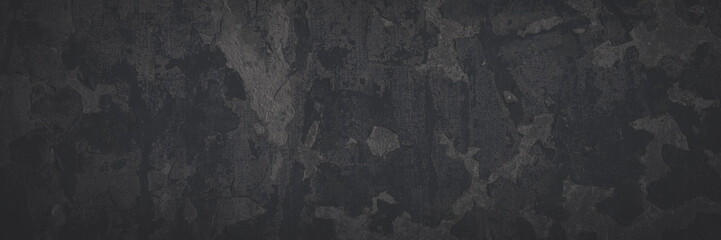 Dark wide panoramic background. Peeling paint on a concrete wall. Faded dark texture of old cracked...