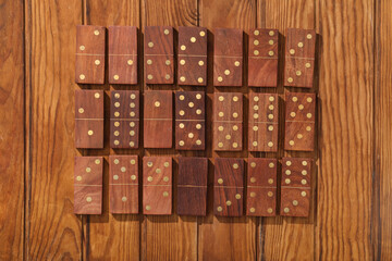 Many dominos blocks on wooden background