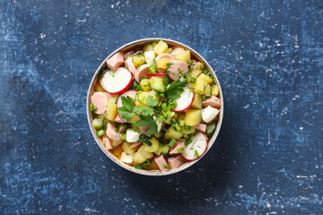 Bowl of tasty okroshka on color background