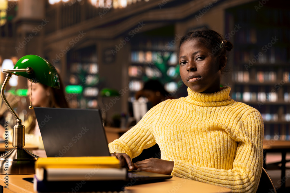 Poster schoolgirl reading information via internet and taking notes in a library, focusing on theoretical s
